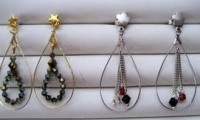Pendientes con metal ovalado uno  dorado con rocalla de cristal negro el otro plateado con cadena y rocalla de cristal negra y granate